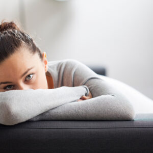 Stressed young housewife in living room